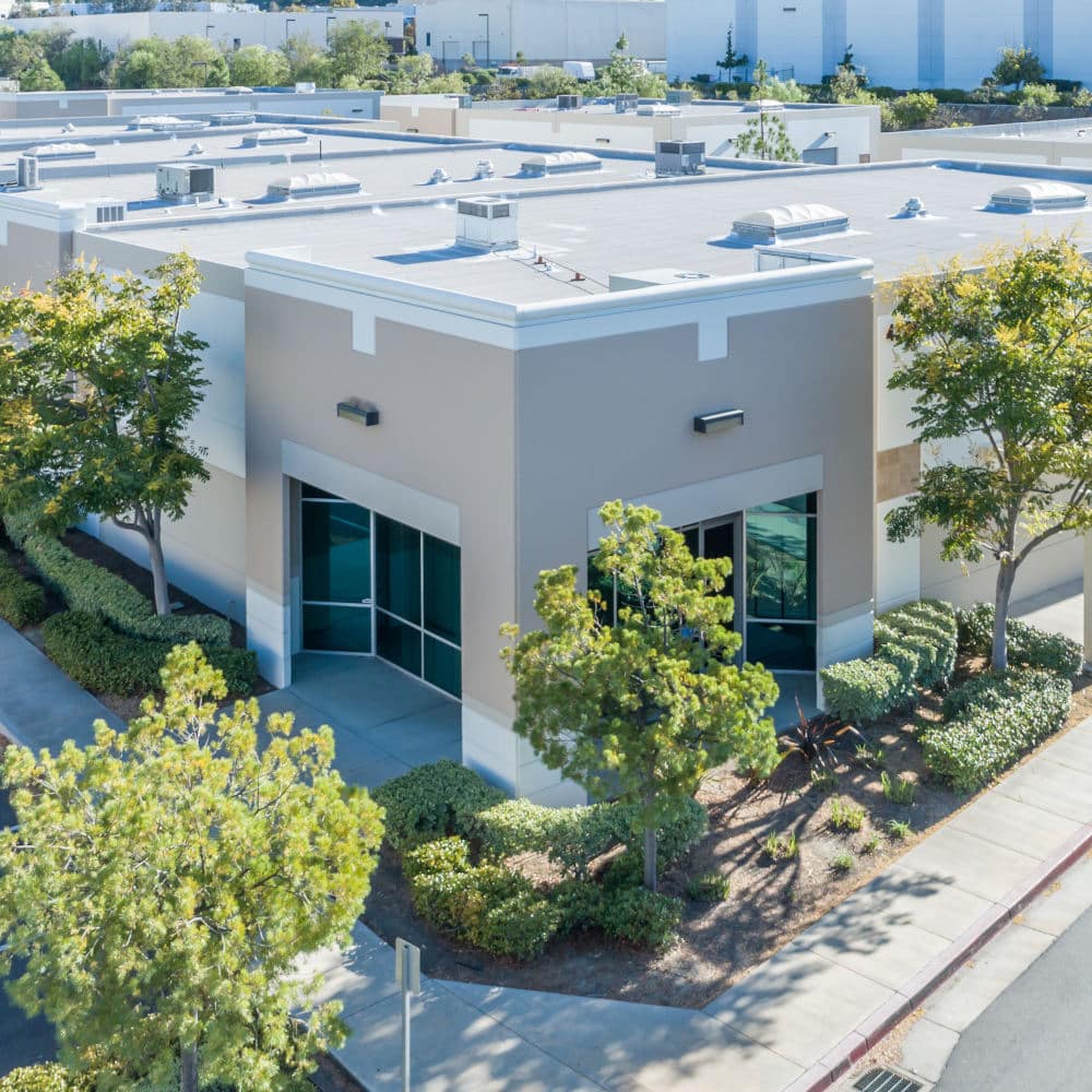 Aerial View Of Industrial Commerce Office Buildings with flat roofs.