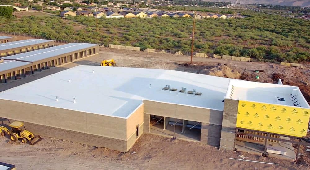 aerial view of a large commercial building with a flat roof