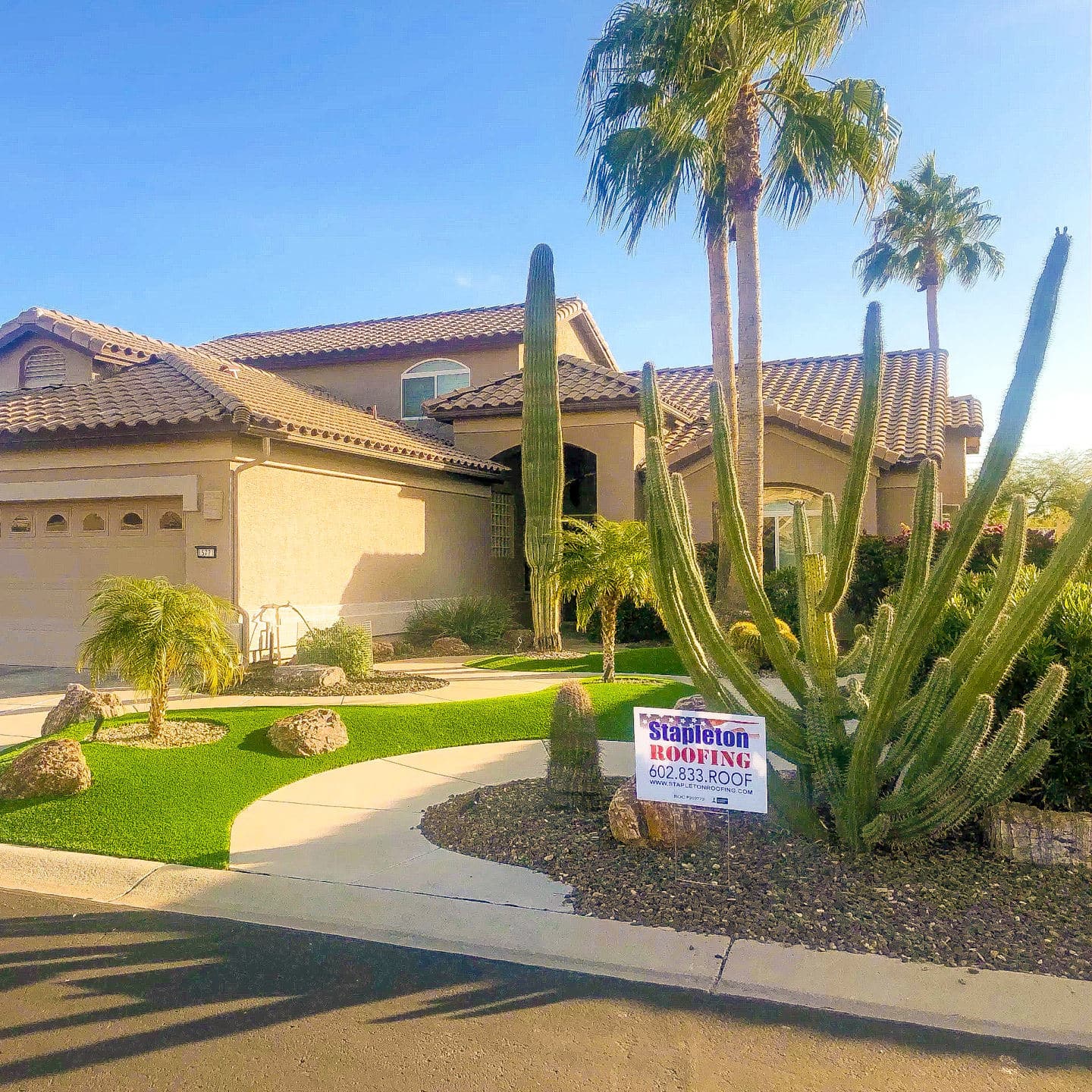 Residential house with a tile roof and Stapleton Roofing sign in the front yard