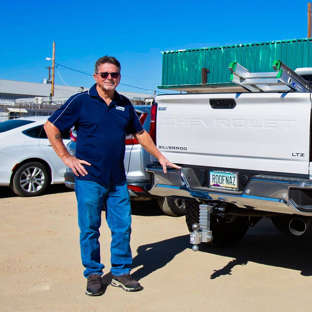 stapleton roofing owner pat standing by a roofing company truck