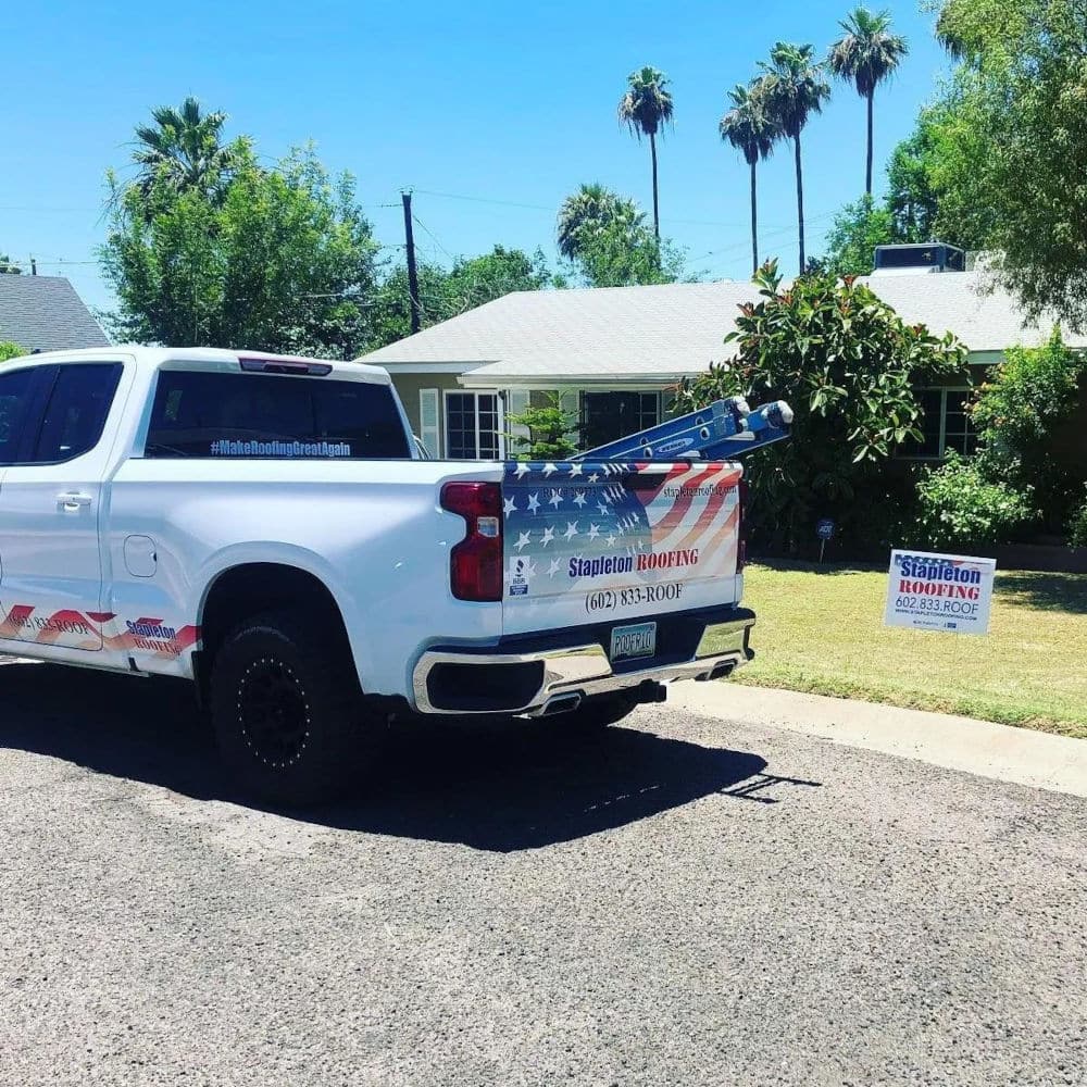 stapleton roofing truck in front of customer house with lawn sign