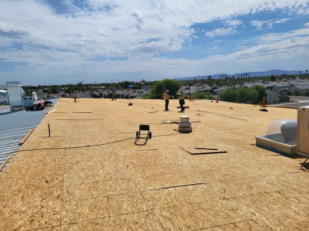 Plywood decking installation over existing metal roof panels Phoenix AZ