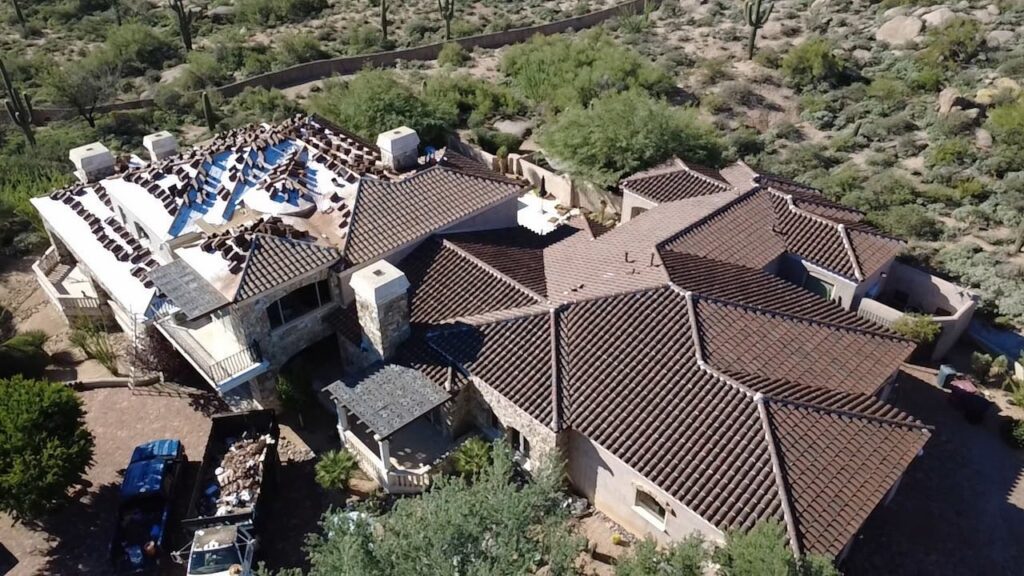 Tile R&R in progress on a large Scottsdale home, with tiles stacked and new underlayment going down
